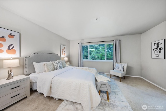 bedroom featuring light colored carpet and baseboards