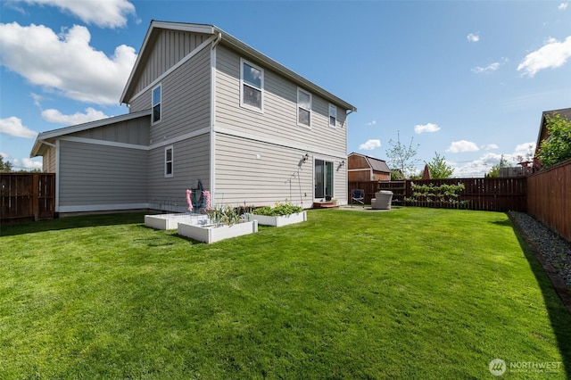 1630 Aaron Dr, Lynden, WA 98264 - back of property with board and batten siding and a vegetable garden