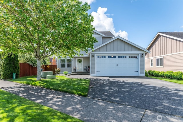 1630 Aaron Dr, Lynden, WA 98264 - view of front of house with board and batten siding, an attached garage, and driveway