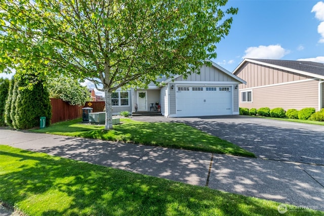 1630 Aaron Dr, Lynden, WA 98264 - view of front facade with asphalt driveway, board and batten siding, and an attached garage