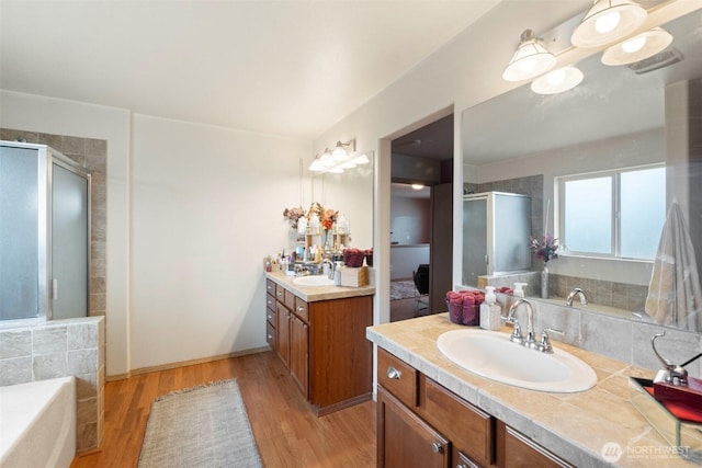 14944 Terra View St SE, Yelm, WA 98597 - bathroom featuring a stall shower, wood finished floors, two vanities, and a bath
