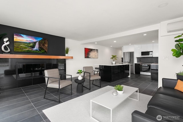 living area with dark tile patterned flooring and recessed lighting