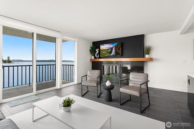 living room featuring tile patterned floors, baseboards, and floor to ceiling windows
