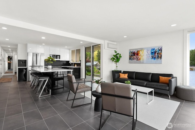 living area featuring dark tile patterned flooring and recessed lighting