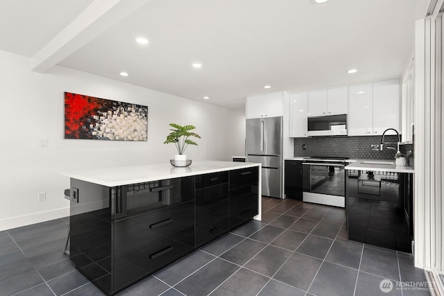 kitchen featuring freestanding refrigerator, modern cabinets, white microwave, electric range oven, and a sink