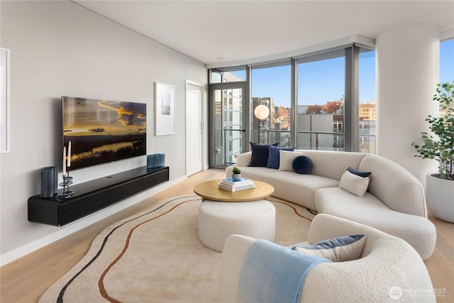 2510 6th Ave Unit 602, Seattle, WA 98121 - living area with wood finished floors, baseboards, and a wall of windows