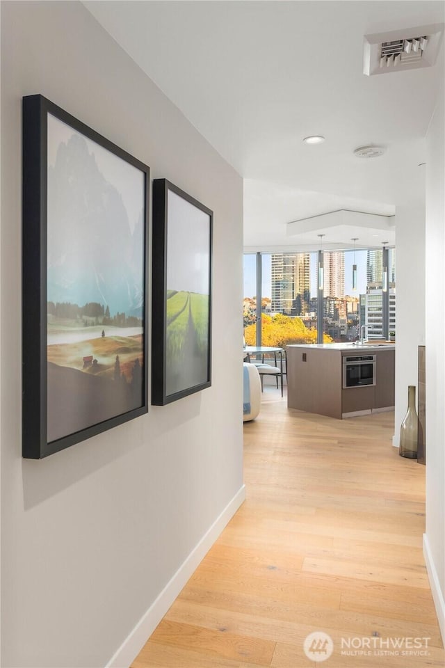 2510 6th Ave Unit 602, Seattle, WA 98121 - corridor with baseboards, wood finished floors, and recessed lighting