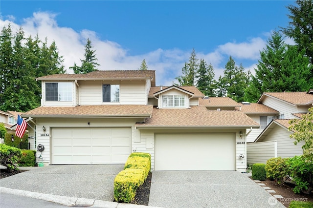 townhome / multi-family property featuring asphalt driveway and a shingled roof