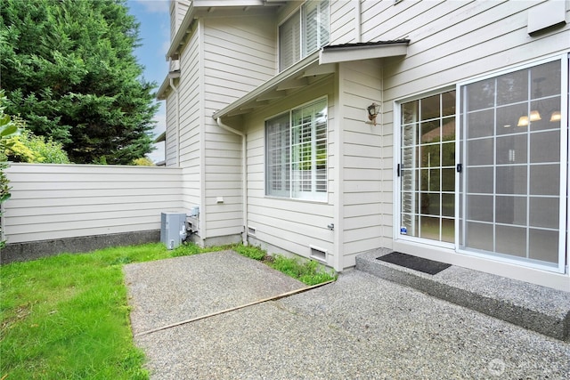 doorway to property featuring a patio area and fence