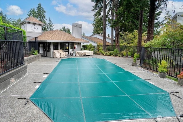 view of swimming pool featuring a fenced backyard and a patio area
