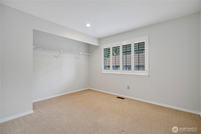 unfurnished bedroom featuring carpet, baseboards, a closet, and recessed lighting