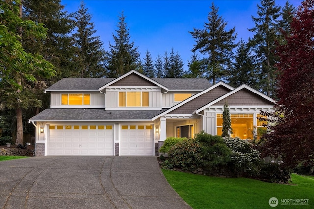 1893 Commodore Ln NW, Bainbridge Island, WA 98110 - view of front of property with board and batten siding, an attached garage, concrete driveway, and stone siding