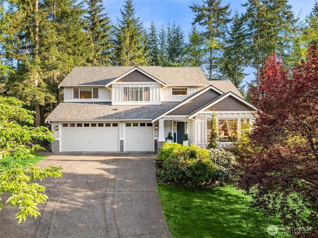 1893 Commodore Ln NW, Bainbridge Island, WA 98110 - view of front of home featuring concrete driveway, an attached garage, board and batten siding, a shingled roof, and a front yard