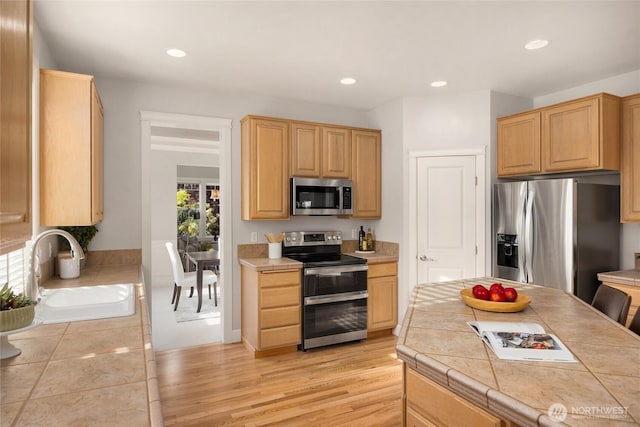 1893 Commodore Ln NW, Bainbridge Island, WA 98110 - kitchen featuring stainless steel appliances, a sink, tile counters, light brown cabinets, and recessed lighting