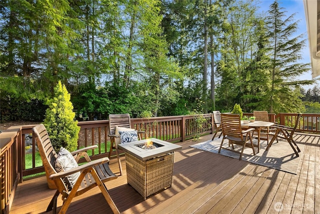 1893 Commodore Ln NW, Bainbridge Island, WA 98110 - wooden deck with a fire pit, outdoor dining area, and view of wooded area