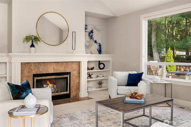 1893 Commodore Ln NW, Bainbridge Island, WA 98110 - living room featuring lofted ceiling, a tiled fireplace, and baseboards