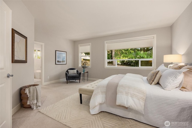 1893 Commodore Ln NW, Bainbridge Island, WA 98110 - carpeted bedroom with multiple windows, baseboards, and connected bathroom