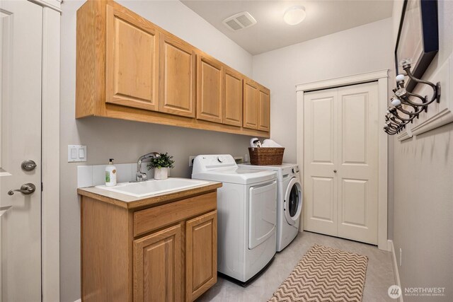 1893 Commodore Ln NW, Bainbridge Island, WA 98110 - laundry room featuring washing machine and clothes dryer, cabinet space, and light tile patterned floors