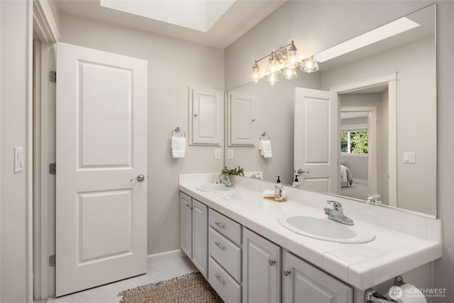 1893 Commodore Ln NW, Bainbridge Island, WA 98110 - bathroom featuring double vanity, ensuite bathroom, baseboards, and tile patterned flooring