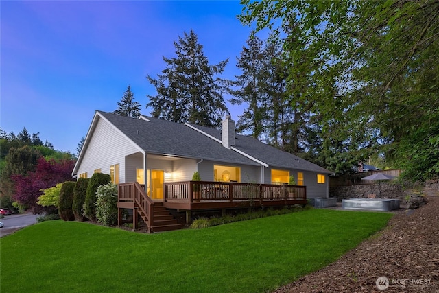 1893 Commodore Ln NW, Bainbridge Island, WA 98110 - rear view of house with a chimney, a lawn, a deck, and a shingled roof