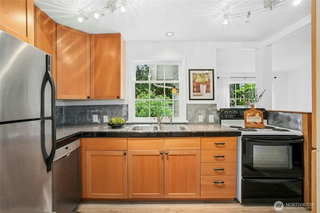10515 NE 189th St, Bothell, WA 98011 - kitchen with freestanding refrigerator, electric range, dishwasher, a sink, and light wood-style flooring