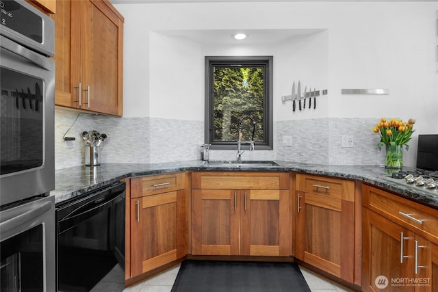5107 23rd Ave W, Everett, WA 98203 - kitchen with a sink, dark stone counters, stainless steel double oven, and brown cabinets