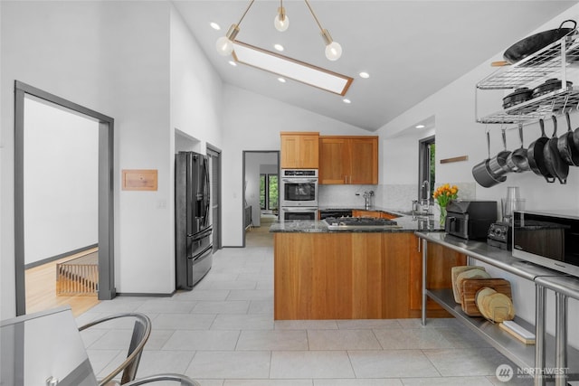 5107 23rd Ave W, Everett, WA 98203 - kitchen featuring brown cabinetry, stainless steel double oven, a skylight, a peninsula, and black refrigerator with ice dispenser