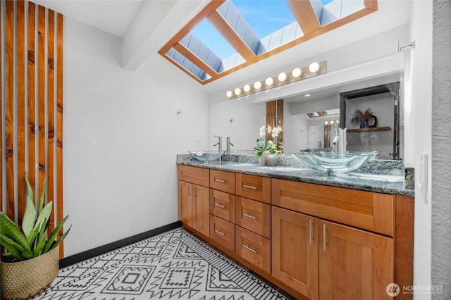 5107 23rd Ave W, Everett, WA 98203 - full bath featuring a sink, baseboards, lofted ceiling with skylight, and double vanity