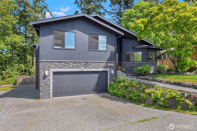 5107 23rd Ave W, Everett, WA 98203 - view of front facade with a garage, fence, driveway, and stone siding