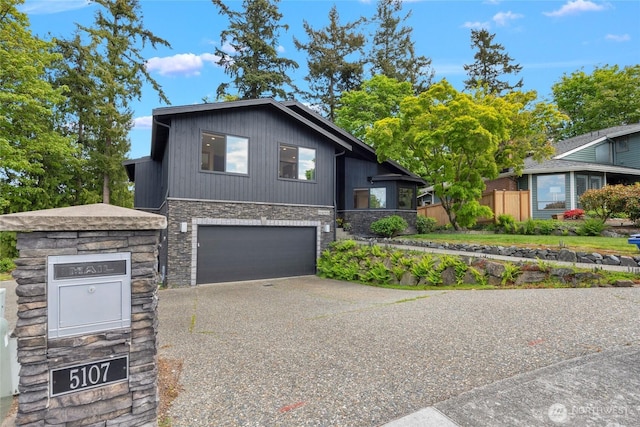5107 23rd Ave W, Everett, WA 98203 - split level home with fence, an attached garage, aphalt driveway, and stone siding