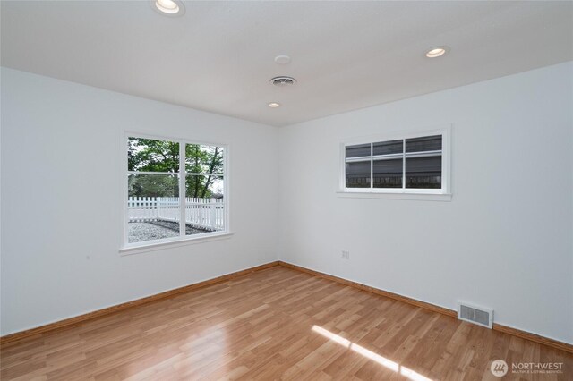 unfurnished room with visible vents, recessed lighting, baseboards, and light wood-type flooring