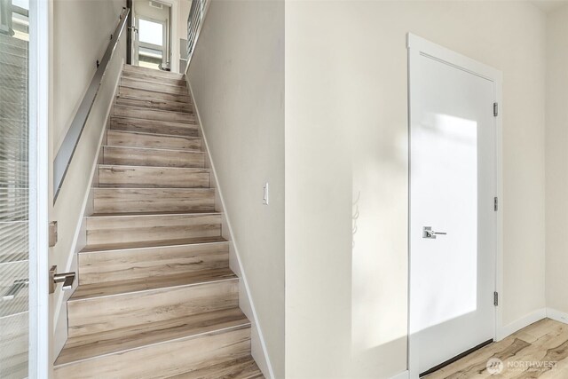 stairs featuring baseboards and wood finished floors