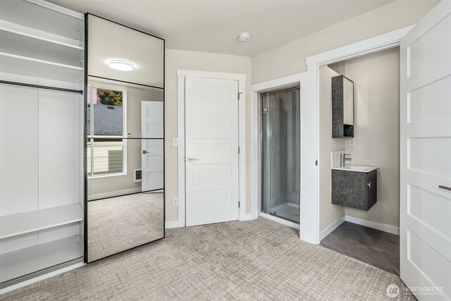full bath with vanity, baseboards, and a stall shower