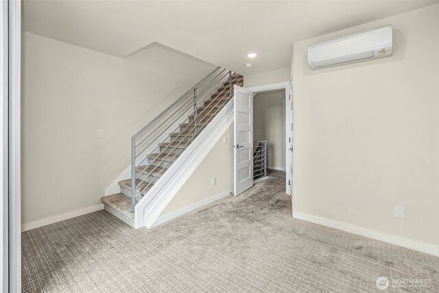 stairs featuring recessed lighting, baseboards, an AC wall unit, and carpet flooring