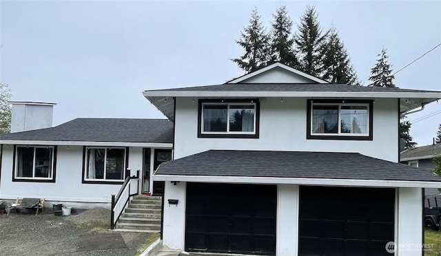 1017 Ballentine St, Raymond, WA 98577 - tri-level home featuring a garage, a shingled roof, and a chimney