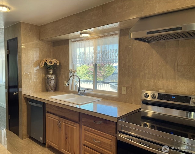 1017 Ballentine St, Raymond, WA 98577 - kitchen featuring a sink, light countertops, range hood, and stainless steel appliances