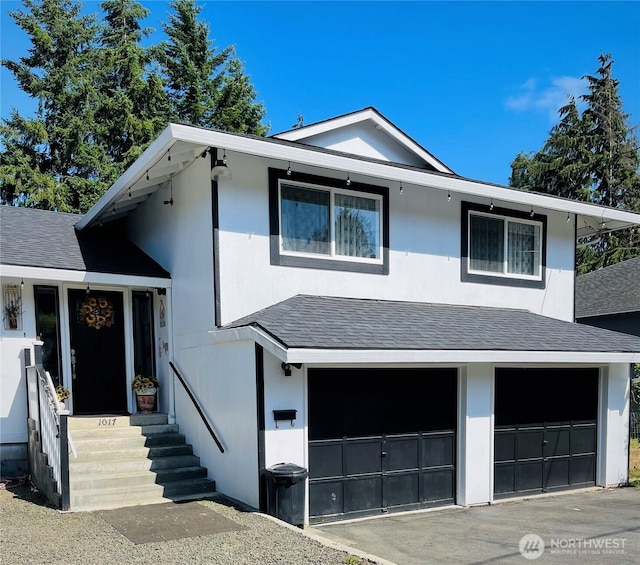 1017 Ballentine St, Raymond, WA 98577 - tri-level home featuring an attached garage, a shingled roof, and stucco siding
