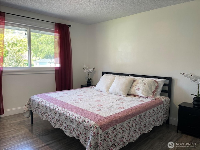 1017 Ballentine St, Raymond, WA 98577 - bedroom with baseboards, dark wood finished floors, and a textured ceiling