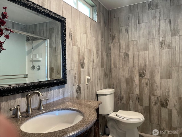 1017 Ballentine St, Raymond, WA 98577 - bathroom with vanity, toilet, tile walls, decorative backsplash, and a shower stall