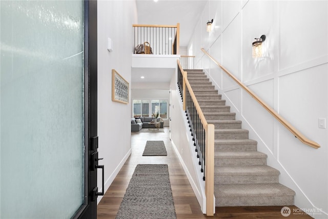 12402 40th Ave NW, Gig Harbor, WA 98332 - stairs featuring baseboards, a towering ceiling, and wood finished floors