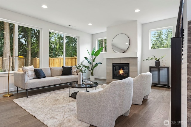 12402 40th Ave NW, Gig Harbor, WA 98332 - living area featuring plenty of natural light, baseboards, wood finished floors, and a tile fireplace