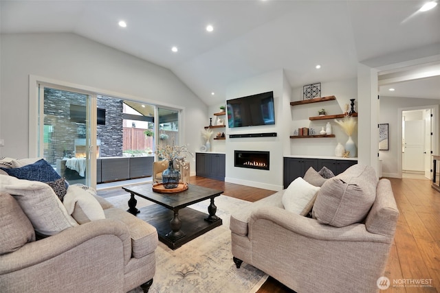 living room featuring lofted ceiling, a warm lit fireplace, recessed lighting, and light wood-type flooring