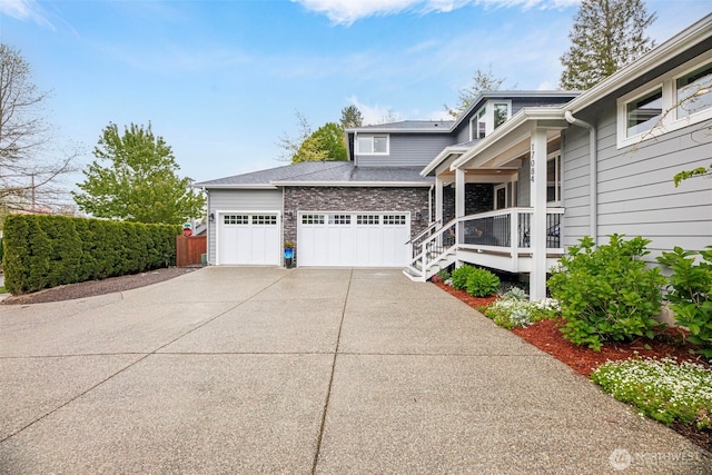 view of front of house with covered porch, concrete driveway, and a garage