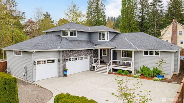 prairie-style house featuring concrete driveway, a porch, roof with shingles, and an attached garage