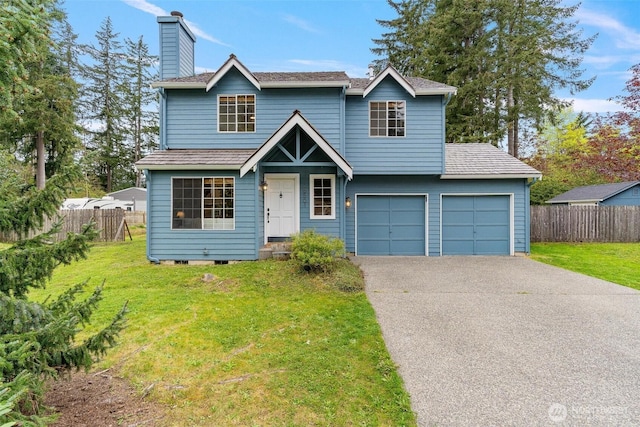 traditional home featuring a front lawn, aphalt driveway, and fence