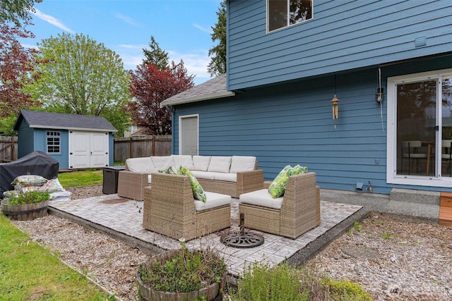view of patio with an outdoor living space, a fenced backyard, a shed, and an outbuilding