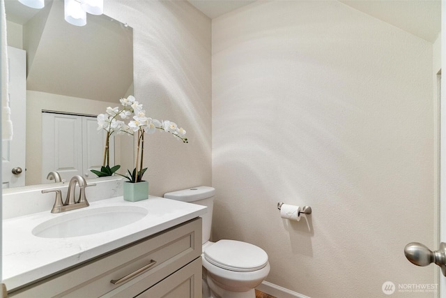 half bath with vanity and toilet