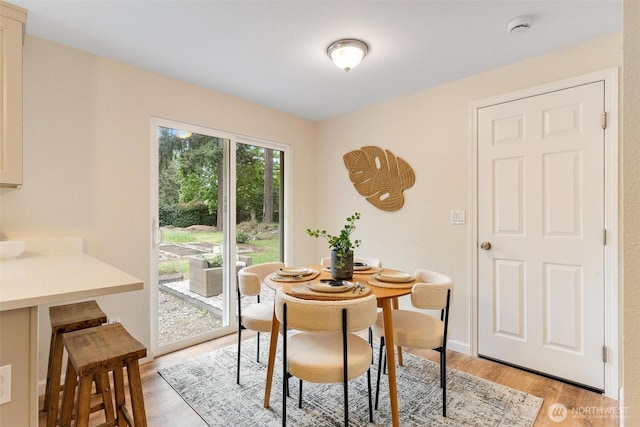 dining space featuring light wood-type flooring