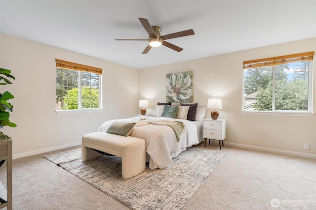 carpeted bedroom with baseboards and a ceiling fan