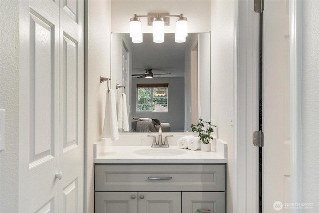 bathroom with ceiling fan, ensuite bathroom, and vanity